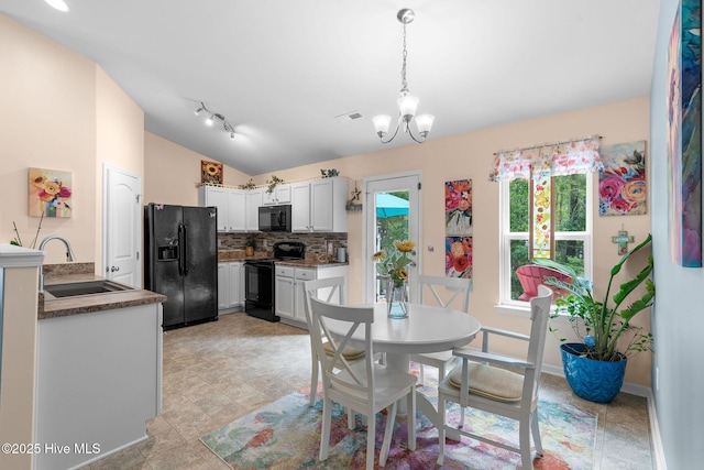 1516 Round Ridge Rd SE, Bolivia, NC 28422 - dining room with baseboards, vaulted ceiling, an inviting chandelier, and visible vents