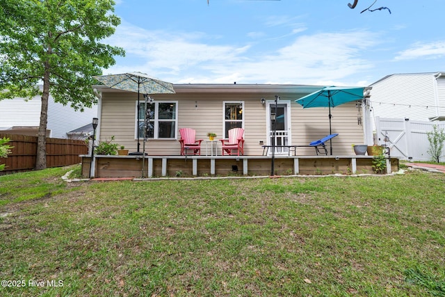 1516 Round Ridge Rd SE, Bolivia, NC 28422 - rear view of house featuring a fenced backyard and a lawn
