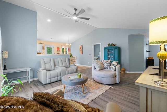 1516 Round Ridge Rd SE, Bolivia, NC 28422 - living room with baseboards, ceiling fan with notable chandelier, wood finished floors, and lofted ceiling