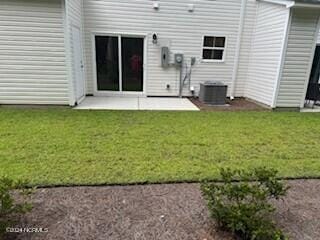 5034 Northstar Dr Unit 68, Leland, NC 28451 - back of house featuring a patio area, a lawn, and central AC