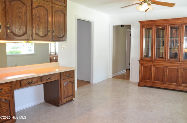 101 N Channel Haven Dr, Wilmington, NC 28409 - kitchen featuring a ceiling fan, light countertops, brown cabinetry, and light floors