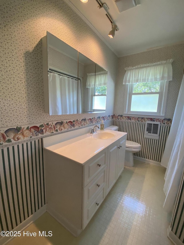 101 N Channel Haven Dr, Wilmington, NC 28409 - full bathroom with wallpapered walls, track lighting, vanity, toilet, and a shower with shower curtain