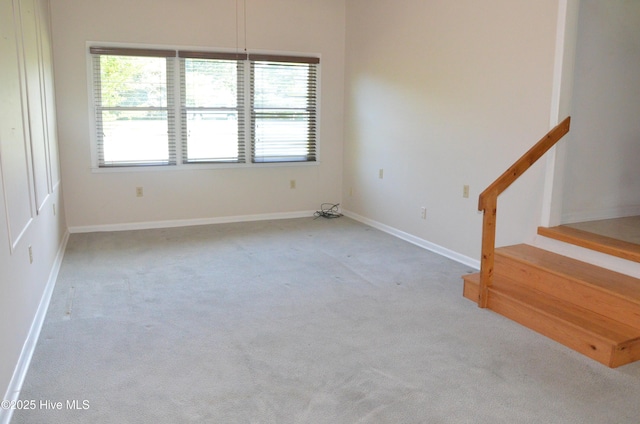 101 N Channel Haven Dr, Wilmington, NC 28409 - carpeted empty room with healthy amount of natural light, stairs, and baseboards