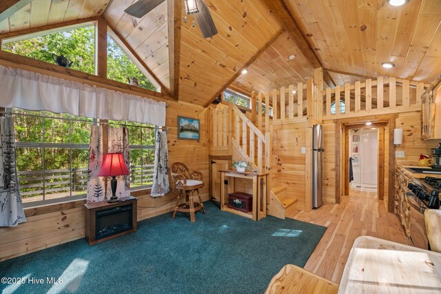 280 Charlie Rd, Arapahoe, NC 28510 - sitting room with wooden walls, high vaulted ceiling, and stairway