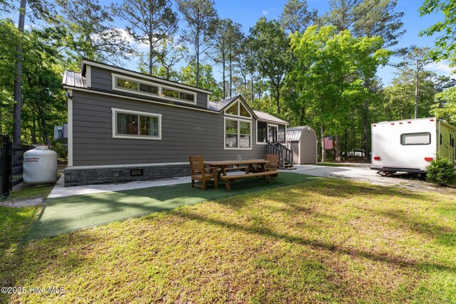 280 Charlie Rd, Arapahoe, NC 28510 - rear view of property featuring a storage shed, an outbuilding, a yard, and crawl space