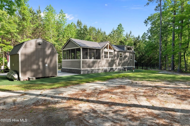 280 Charlie Rd, Arapahoe, NC 28510 - rear view of house with a sunroom, an outdoor structure, and a shed