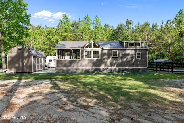 280 Charlie Rd, Arapahoe, NC 28510 - rear view of property with crawl space, metal roof, a storage shed, a lawn, and an outbuilding