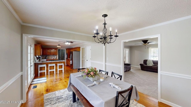 106 Ehrhardt Way, Princeton, NC 27569 - dining area with light wood-style floors, ornamental molding, and ceiling fan with notable chandelier