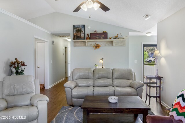 living room featuring wood finished floors, ceiling fan, baseboards, visible vents, and lofted ceiling