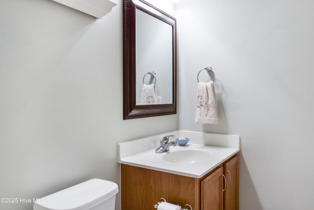 bathroom with toilet and vanity