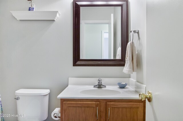 bathroom with toilet and vanity
