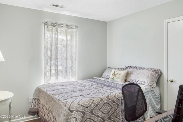 bedroom featuring visible vents