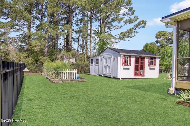 view of yard with fence and an outdoor structure