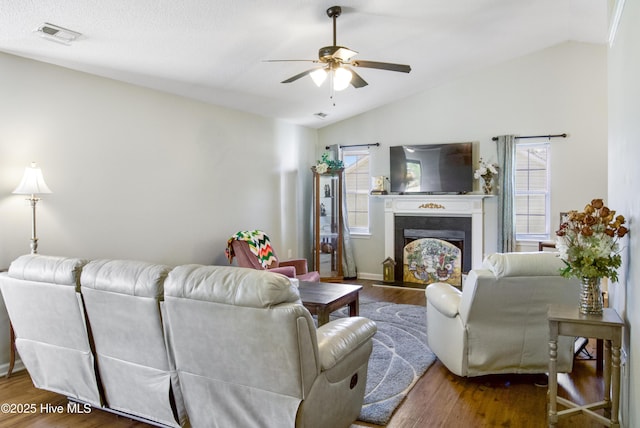living room featuring lofted ceiling, a wealth of natural light, ceiling fan, and wood finished floors