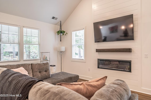102 Dartmoor Ln, West End, NC 27376 - living area with wood finished floors, a fireplace, baseboards, visible vents, and lofted ceiling