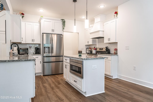 102 Dartmoor Ln, West End, NC 27376 - kitchen featuring dark wood-type flooring, stainless steel appliances, and decorative backsplash
