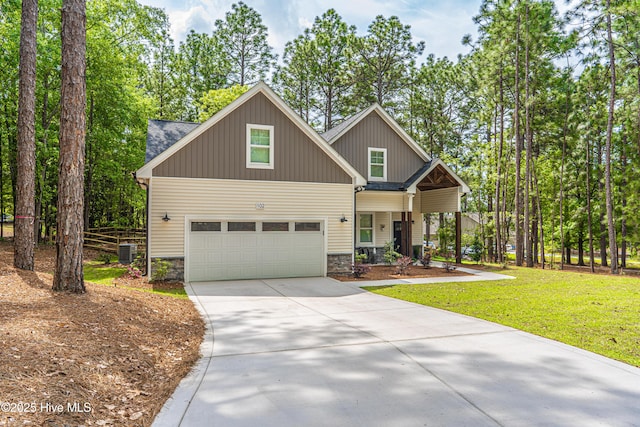 102 Dartmoor Ln, West End, NC 27376 - craftsman-style house featuring a garage, stone siding, cooling unit, a front yard, and concrete driveway