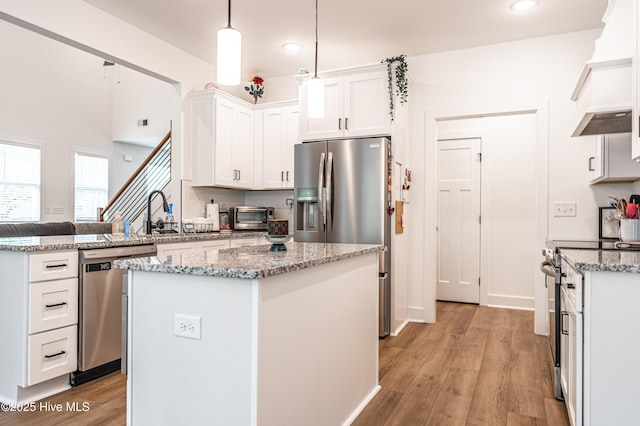 102 Dartmoor Ln, West End, NC 27376 - kitchen featuring recessed lighting, stainless steel appliances, light wood-type flooring, light stone counters, and white cabinets