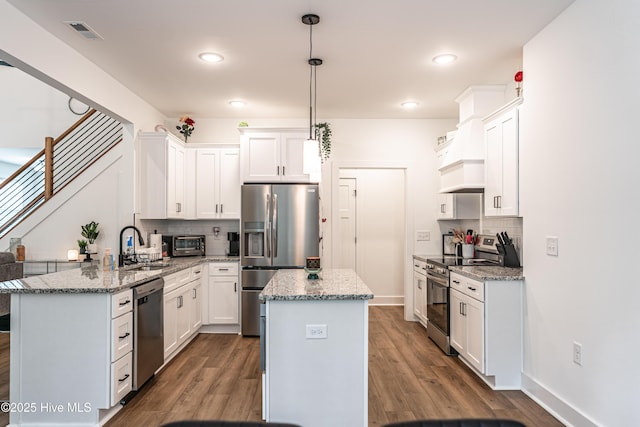102 Dartmoor Ln, West End, NC 27376 - kitchen featuring tasteful backsplash, stainless steel appliances, dark wood-style flooring, and a sink
