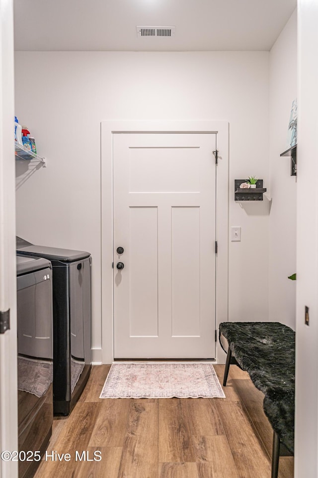 102 Dartmoor Ln, West End, NC 27376 - clothes washing area featuring visible vents, wood finished floors, laundry area, and independent washer and dryer