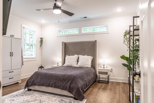 102 Dartmoor Ln, West End, NC 27376 - bedroom featuring wood finished floors, visible vents, crown molding, and baseboards