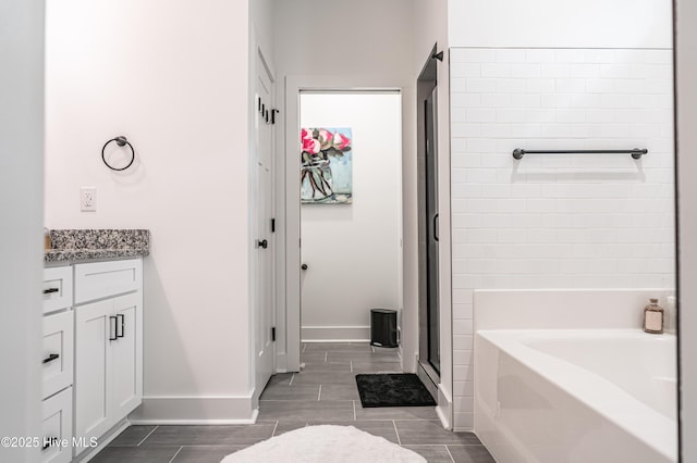 102 Dartmoor Ln, West End, NC 27376 - bathroom featuring a shower stall, a bath, vanity, baseboards, and wood tiled floor