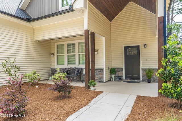 102 Dartmoor Ln, West End, NC 27376 - property entrance featuring a porch, stone siding, and board and batten siding