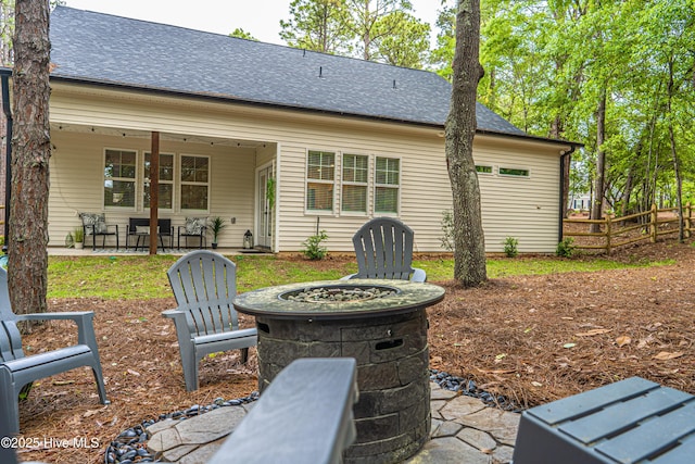 102 Dartmoor Ln, West End, NC 27376 - rear view of property with fence, a shingled roof, a fire pit, and a patio area