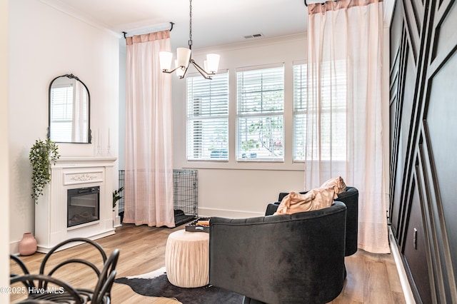 102 Dartmoor Ln, West End, NC 27376 - sitting room with visible vents, an inviting chandelier, wood finished floors, and ornamental molding
