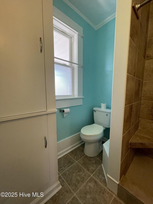 469 Lamont St, Belhaven, NC 27810 - bathroom with tile patterned floors, crown molding, tiled shower, and toilet
