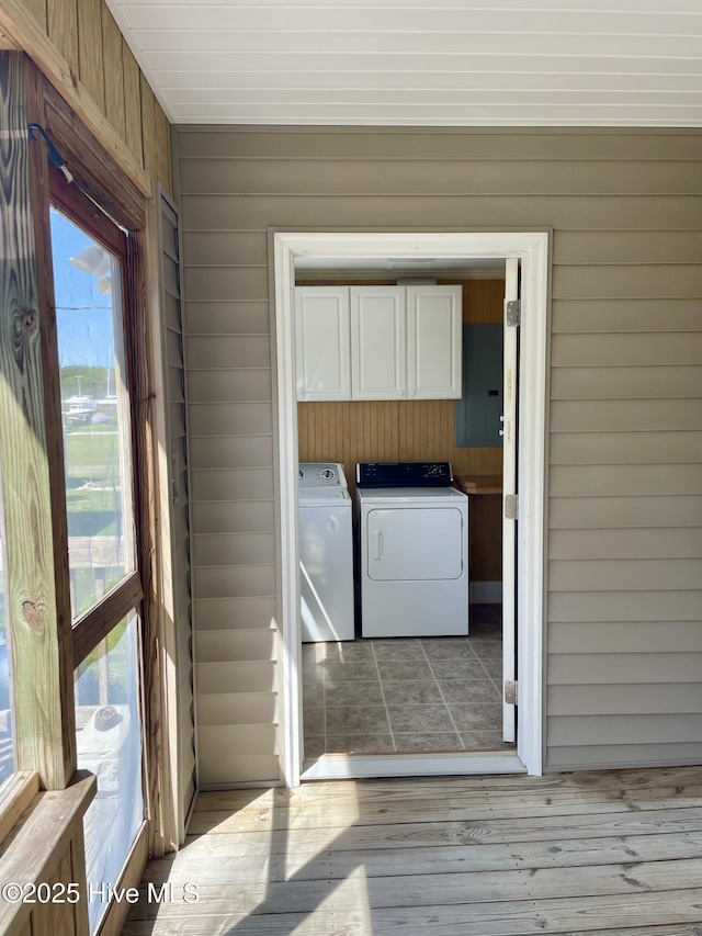 469 Lamont St, Belhaven, NC 27810 - washroom with cabinet space, wood finished floors, wood walls, and separate washer and dryer