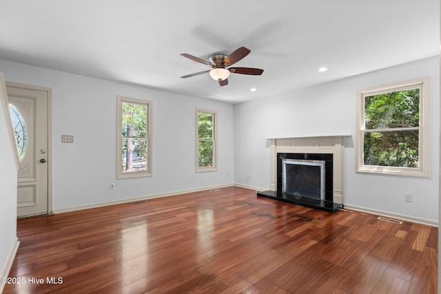 520 E Ohio Ave, Southern Pines, NC 28387 - unfurnished living room with visible vents, a ceiling fan, wood finished floors, and a tiled fireplace