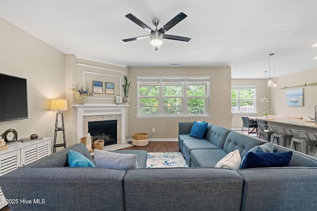 1699 Haldon Ln SE, Bolivia, NC 28422 - living area featuring baseboards, ceiling fan, wood finished floors, and a fireplace