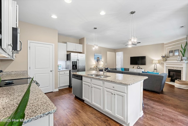 1699 Haldon Ln SE, Bolivia, NC 28422 - kitchen with white cabinets, ceiling fan, a sink, dark wood finished floors, and stainless steel appliances