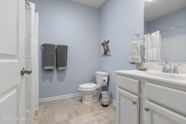 1699 Haldon Ln SE, Bolivia, NC 28422 - full bathroom featuring vanity, curtained shower, toilet, baseboards, and stone finish flooring
