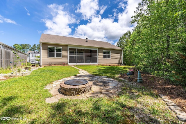 1699 Haldon Ln SE, Bolivia, NC 28422 - back of house with a yard, a sunroom, and an outdoor fire pit