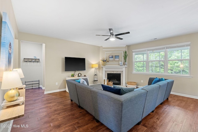 1699 Haldon Ln SE, Bolivia, NC 28422 - living area with a stone fireplace, dark wood finished floors, ceiling fan, and baseboards
