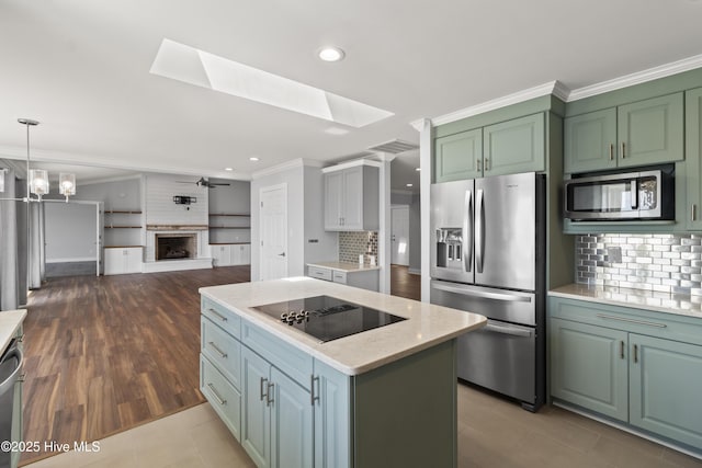 995 Chadwick Shores Dr, Sneads Ferry, NC 28460 - kitchen featuring stainless steel appliances, open floor plan, crown molding, decorative backsplash, and a skylight