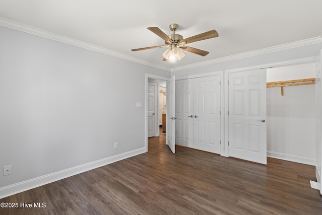 995 Chadwick Shores Dr, Sneads Ferry, NC 28460 - unfurnished bedroom with multiple closets, dark wood-type flooring, baseboards, ornamental molding, and ceiling fan
