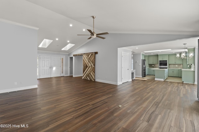 995 Chadwick Shores Dr, Sneads Ferry, NC 28460 - unfurnished living room with a barn door, ceiling fan, recessed lighting, vaulted ceiling, and dark wood-style flooring