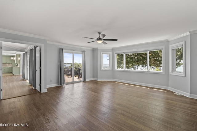 995 Chadwick Shores Dr, Sneads Ferry, NC 28460 - unfurnished room with crown molding, a chandelier, a ceiling fan, dark wood-style floors, and baseboards