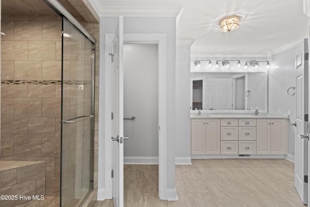 995 Chadwick Shores Dr, Sneads Ferry, NC 28460 - bathroom featuring a stall shower, double vanity, ornamental molding, and baseboards