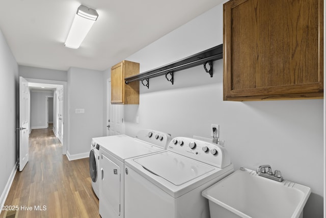 995 Chadwick Shores Dr, Sneads Ferry, NC 28460 - washroom with cabinet space, washer and clothes dryer, wood finished floors, and baseboards