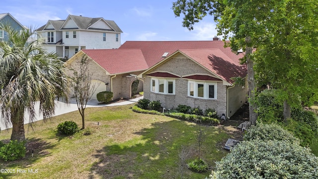 995 Chadwick Shores Dr, Sneads Ferry, NC 28460 - view of front of property with brick siding, an attached garage, a front lawn, and a chimney