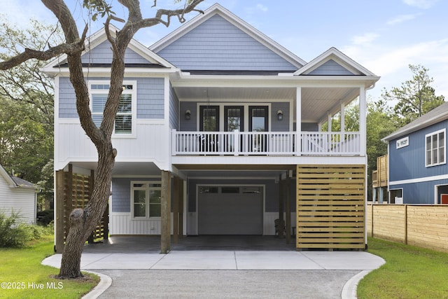 view of front of property featuring a garage, fence, a carport, and driveway