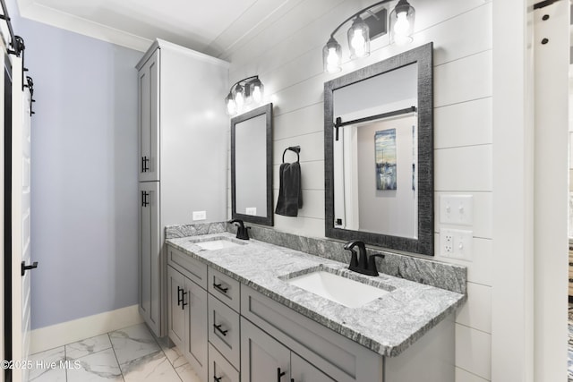 full bathroom with a sink, baseboards, double vanity, and marble finish floor