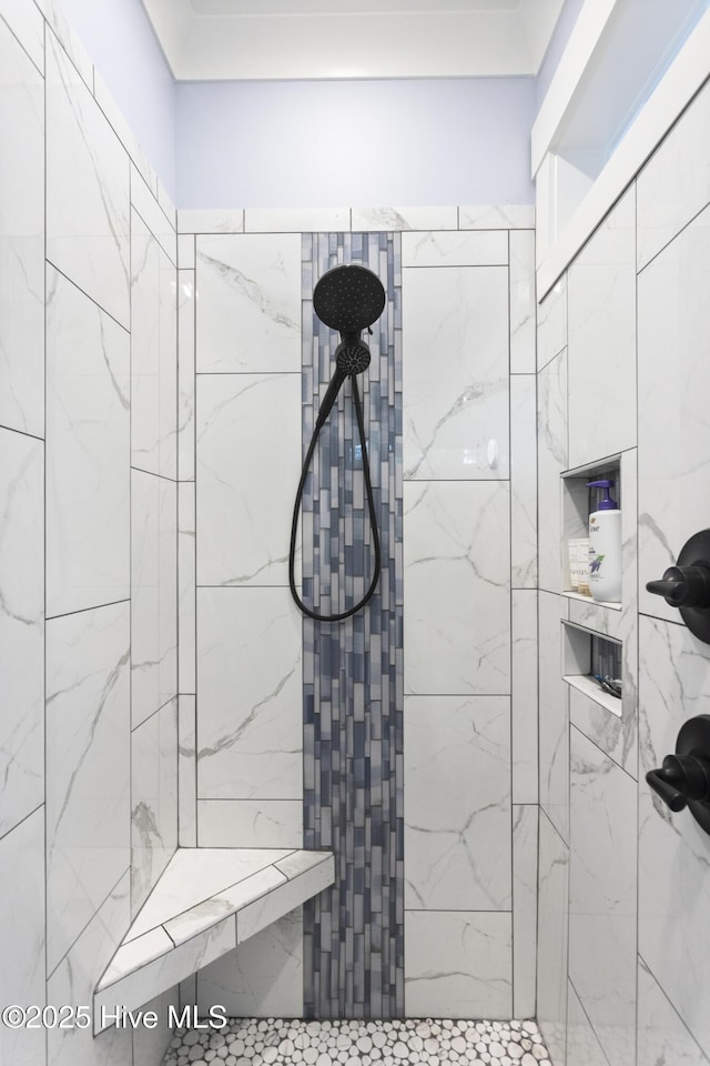 bathroom with a tile shower