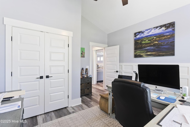 office with light wood-type flooring, ceiling fan, and high vaulted ceiling