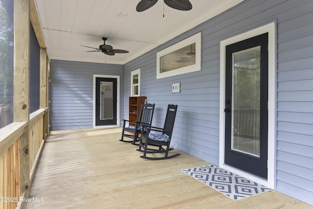 wooden terrace featuring a ceiling fan and a porch
