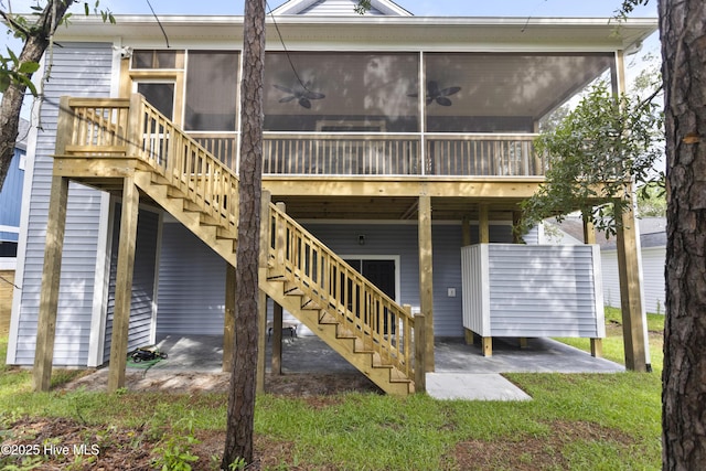 rear view of property with a sunroom and stairs